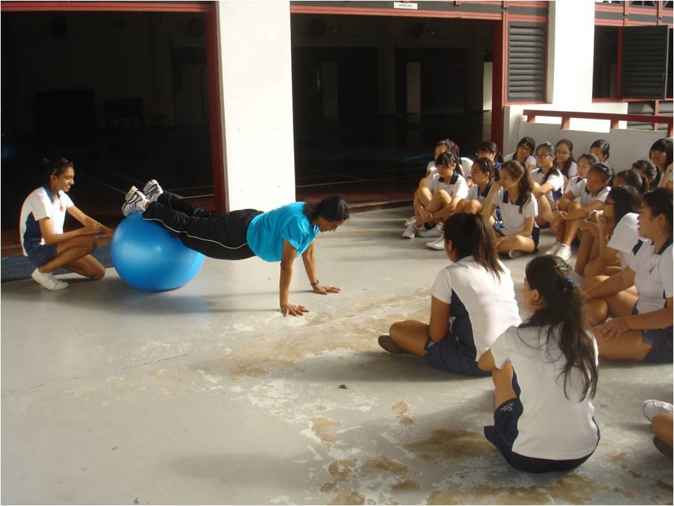 Teaching PE in 2012: Glory demonstrating push ups with a gym ball to her Sec 5 class.